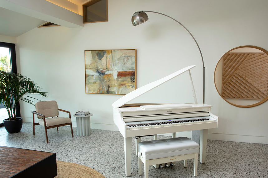 Roland GP-6-PW digital grand piano in polished white – full view in a living room with open lid and bench.