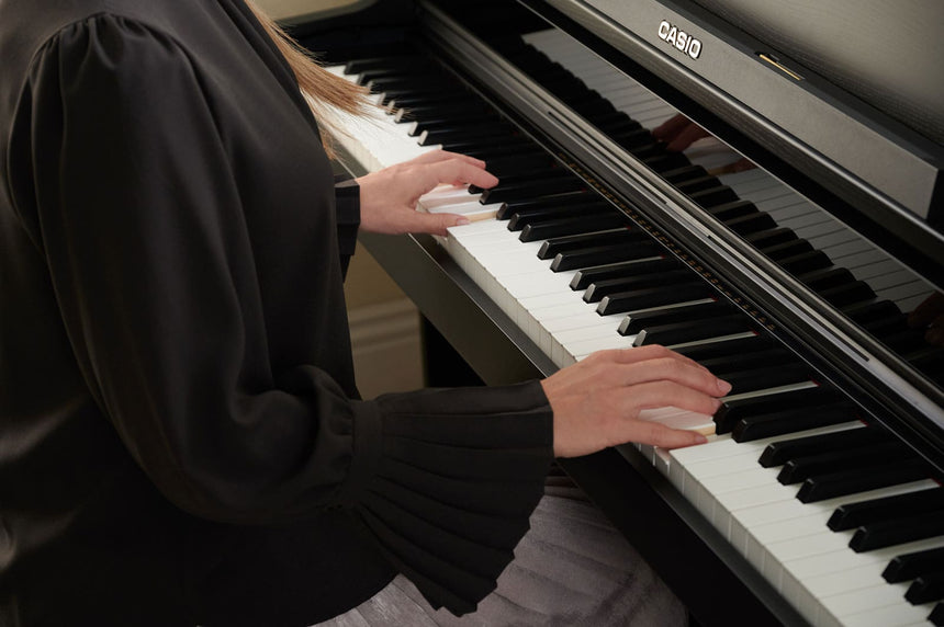 Casio AP-750BK digital piano in black – close view of a pianist at the keyboard.