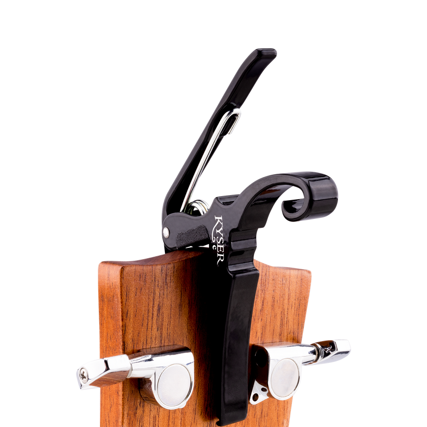 Black Kyser Quick-Change capo for classical guitar, close-up on the neck
