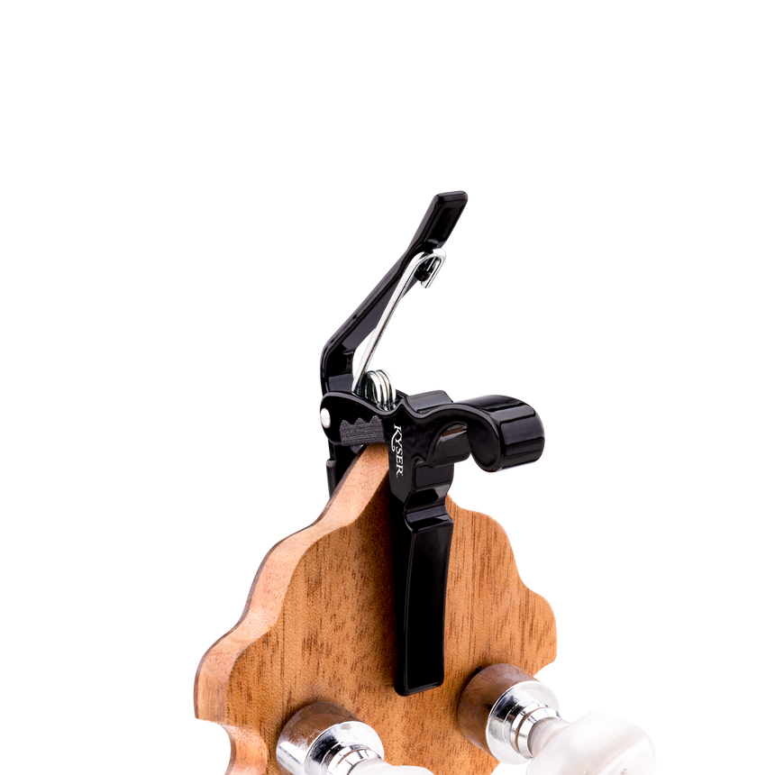 Black Kyser KBMBA Quick-Change capo for banjo, mandolin and ukulele – clipped to a banjo headstock.