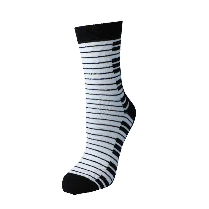 Black Kübler sock stretched to show the black and white keyboard pattern, on white