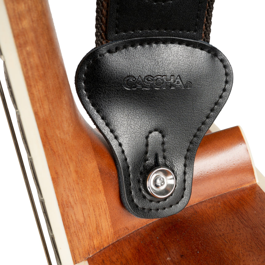 Cascha HH-2259, noir, polyester/coton – extrémité en cuir sur la guitare, gros plan