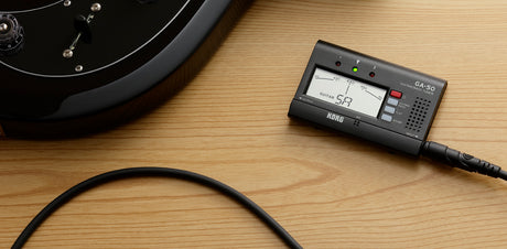 KORG GA-50 guitar and bass tuner connected to an instrument